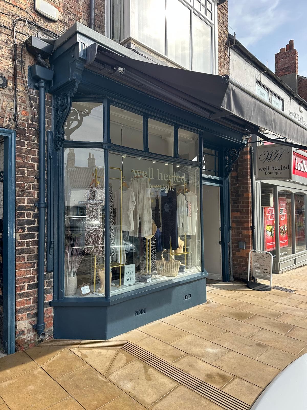 The Well Heeled Boutique storefront window on Market Place, Thirsk